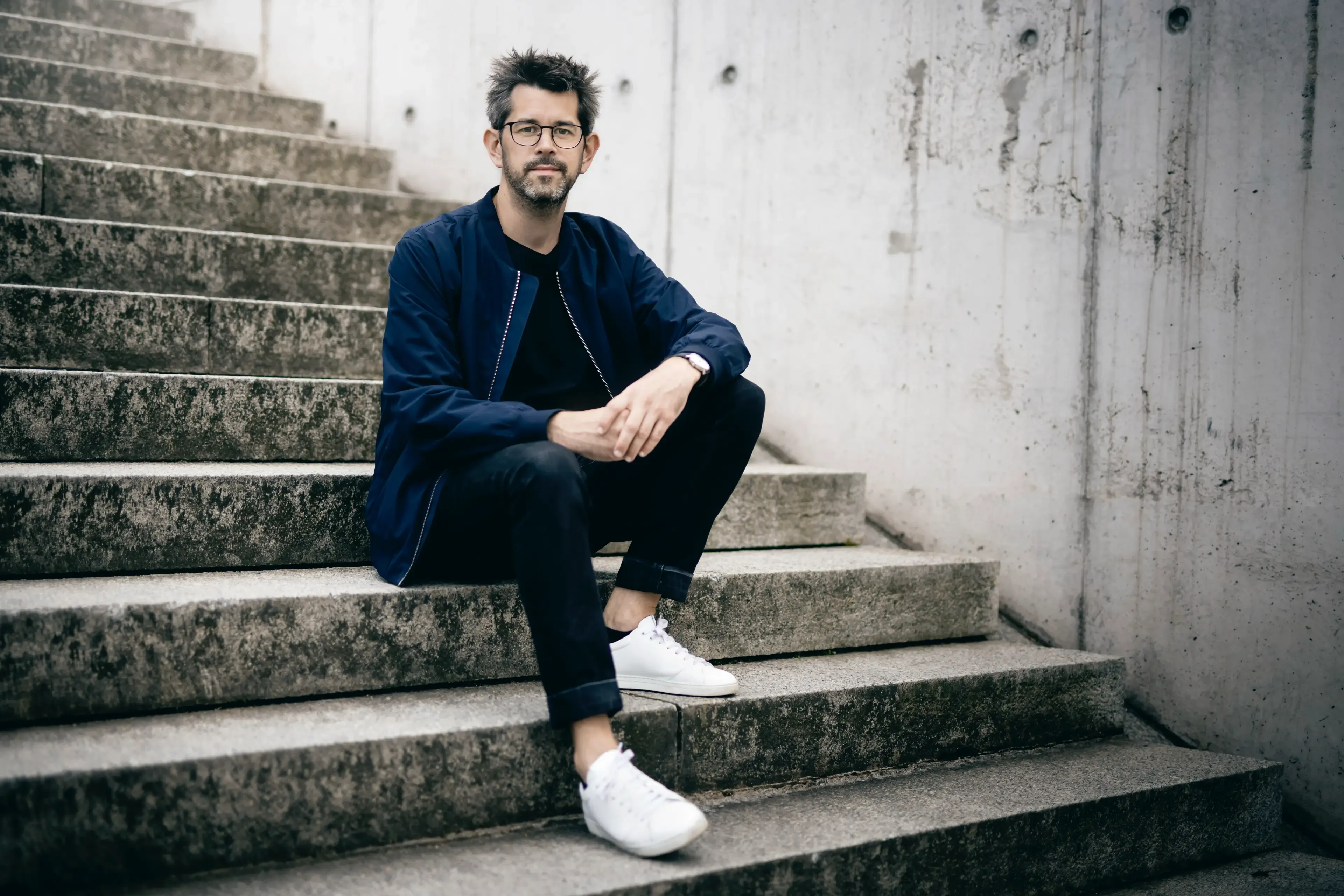 Christoph Steinlehner sitting on a concrete staircase